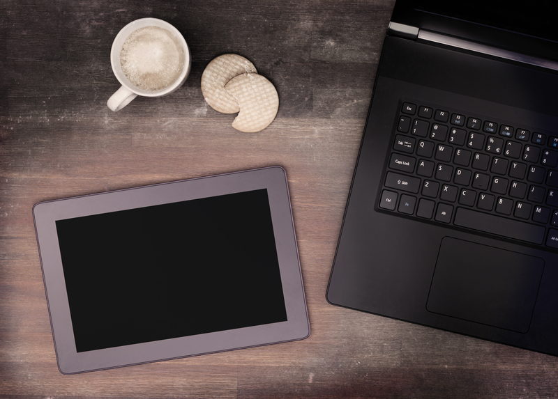 Tablet touch computer gadget on wooden table, vintage look