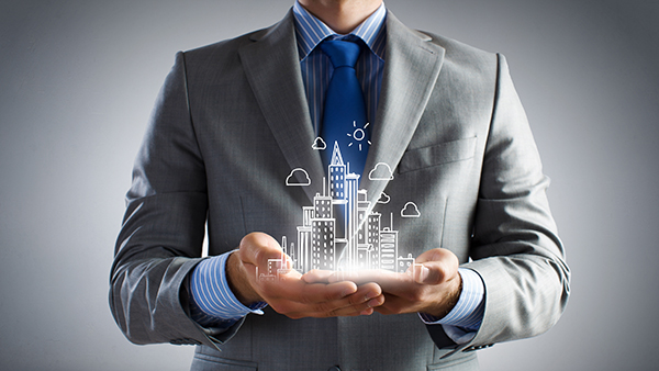 Close up of businessman holding city model in hands